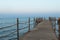 Deserted long old wooden pier at sunset time