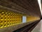 Deserted metro tube with yellow structured wall