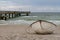 Deserted pier and empty coast and single boat on the shore of the Baltic Sea coast