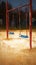 Deserted playground scene with a melancholic empty swing underlining isolation