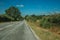 Deserted road passing through rural landscape