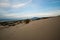 Deserted sandy beach with clean fine sand at sunrise