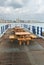 Deserted seats and tables on pier in Eastbourne UK