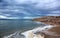 Deserted shore of Dead sea on Jordanian side in off-season, view of Israel, beach is closed during coronavirus infection, COVID-19