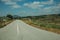 Deserted straight road on rural landscape