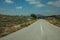 Deserted straight road on rural landscape