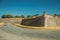 Deserted street with car next to the city wall corner