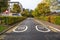 Deserted street with speed limit painted on asphalt and spped bumps