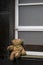 Deserted teddy bear at window