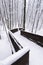 Deserted wooden bridge in winter forest