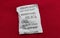 Desiccant silica gel on red background. Synthetic substance absorbing moisture