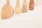 Design concept of mockup of empty wood beige spoons on white wood background.