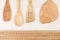 Design concept of mockup of empty wood beige spoons on white wood background.