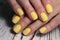 design on yellow manicure