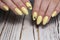 design on yellow manicure