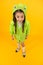 Designed to go to school. Little school girl wearing cute raincoat on yellow background. Small child back to school in