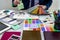 Designer develops a sketch of interior illustration with color scheme of material on a table, office workplace.  Desktop of an