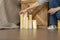 Designer girl arranges decorative candles near bed and bedside table.