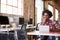 Designer Sits At Meeting Table Working On Digital Tablet