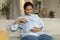 Desirable pregnancy. Happy african american pregnant lady tenderly touching belly, enjoying maternity time