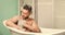 desire and temptation. man wash muscular body with foam sponge. personal care. Sexy man in bathroom. macho man washing