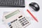 Desk accountant closeup: invoice, keyboard, calculator, mouse, and red pen