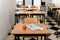 Desk with an apple, medical mask and a copybook in an empty classroom, new normal, back to school during Covid-19