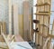 A desk full of wood piles. Wood planks of various sizes lean on a white brick wall. Atmosphere in the workshop room