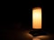 Desk lamp with release orange light like candlelight isolated on dark background