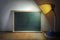 Desk Lamp Shining On Blackboard