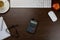 Desk in the office with a smartphone and a red apple in the middle, a notepad and pen, a keyboard next to a cup of coffee -