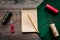 Desk of seamstress. Textile, threads and notebook on dark wooden background top view