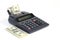 Desktop calculator paper tape with money american hundred dollar bills