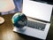 Desktop globe on the modern laptop. Elements of this image furnished by NASA. 3d rendering