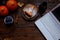 Desktop. Laptop, breakfast, pumpkin cheesecake, table lamp, pumpkins, plums on a wooden table. Home, autumn, cozy