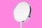 Desktop make up cosmetic mirror isolated on pink background. Home metal mirror close up isolated. Facial mirror.