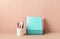Desktop organizer with school stationary and office supplies over pastel background