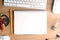 Desktop with paper, stationery, computer, blank notepad and light bulb, top view