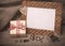 Desktop photo frame and coffee beans with gift box on linen