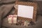 Desktop photo frame and coffee beans with gift box on linen