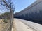 desolate road of cars next to a security fence, road concept