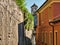 Desolate street with via and stone walls on the San GIulio Island in Lake Orta Italy with the belfry of San Giulio Basilica in the