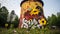 Desolate water tower adorned with vibrant graffiti