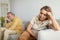 Despaired european senior woman ignoring husband after quarrel, sitting together on sofa, selective focus