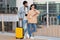 Despaired pensive young multiracial couple in casual and glasses with passport, tickets and suitcase think at airport