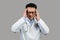 Despaired sad mature chinese man therapist in white coat, glasses suffering from headache, pain and stress