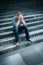 Despaired young man covering his face with hands sitting on stairs