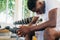 Desperate African American man sitting on bench during break in fitness training in modern gym