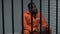 Desperate black prisoner sitting in cell, wrongly accused person, faulty system