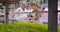 Desperate Caucasian female agronomist in straw hat talking with mature grey-haired male scientist. Man in white robe